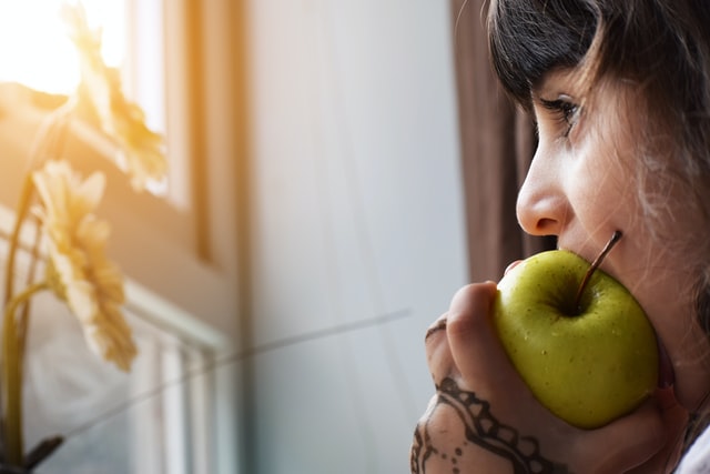 woman biting an apple